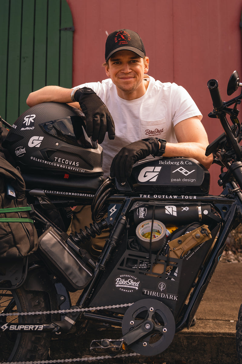 Harry smiling wearing our BSMC Logo Chain embroidered T Shirt  - Off White