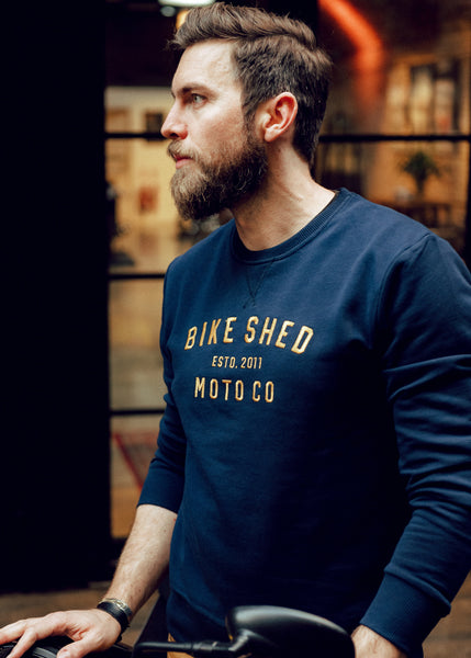 Alen posing, wearing our BSMC Moto Co. logo Sweatshirt - Navy/Mustard