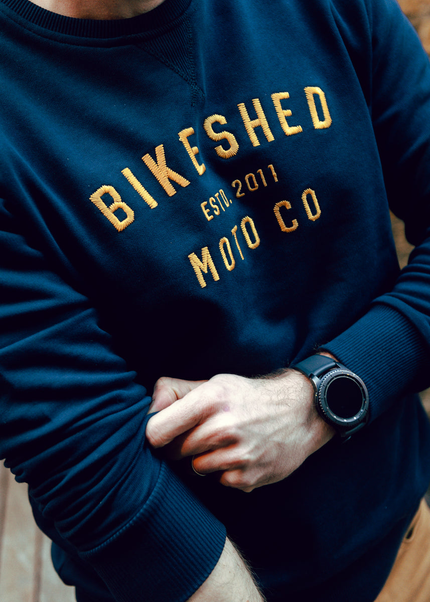 Alen wearing our BSMC Moto Co. logo Sweatshirt - Navy/Mustard, close up