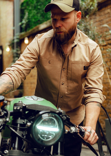 Jimbo pushing his bike wearing our BSMC Ripstop Utility Shirt MKII - TAN