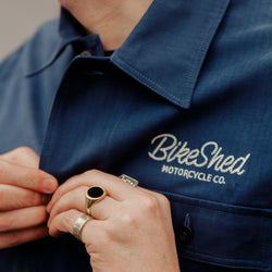 Joe buttoning up our BSMC Chain Stitch Chore Jacket - Blue
