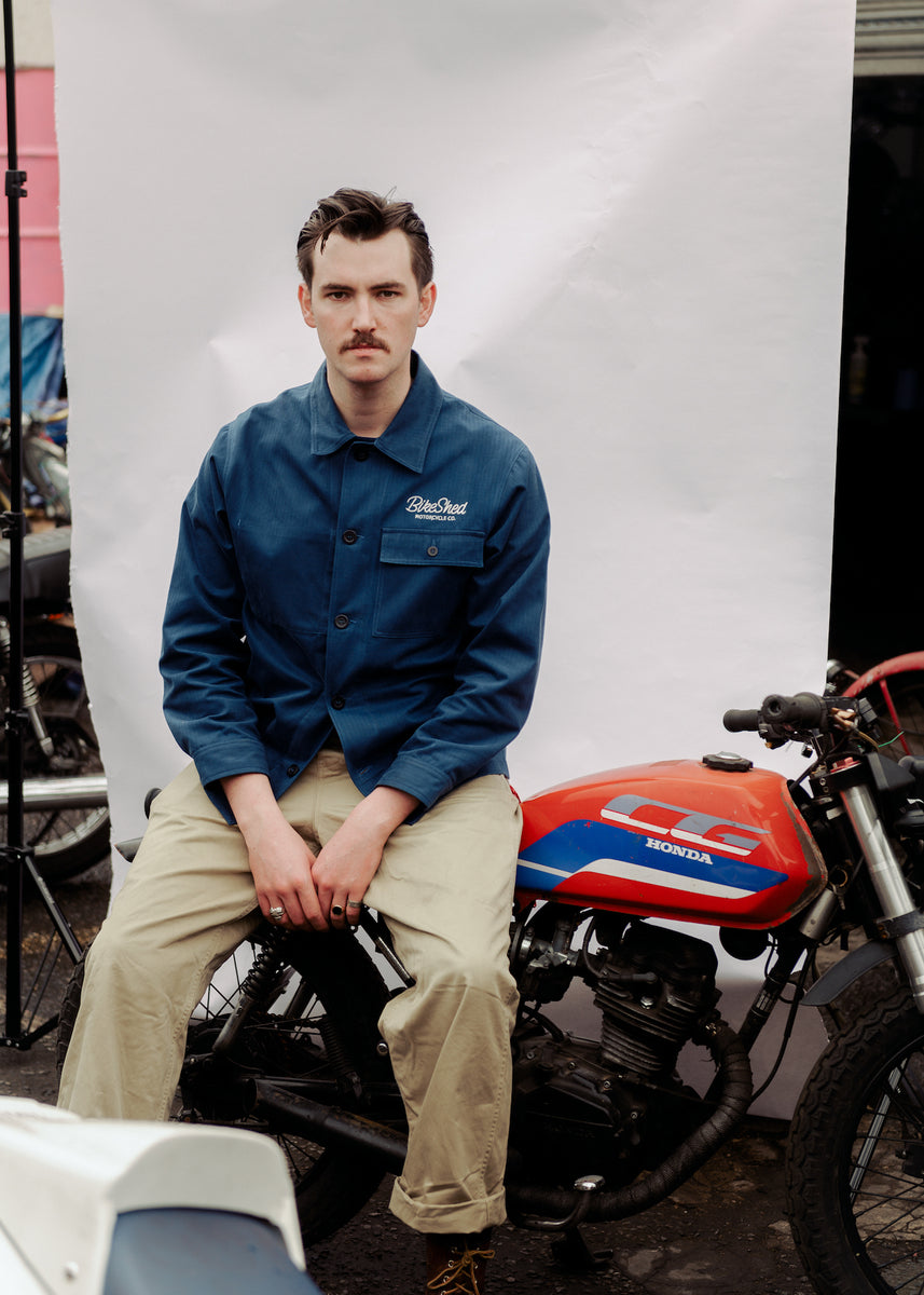 Joe sitting on a Honda CG in our BSMC Chain Stitch Chore Jacket - Blue