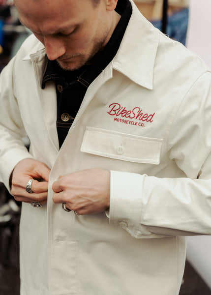 Steve buttoning up our BSMC Chain Chore Jacket - Ecru