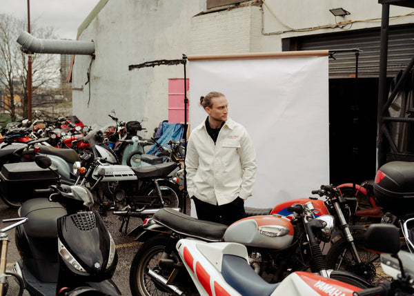 Steve posing amongst bikes in our BSMC Chain Chore Jacket - Ecru