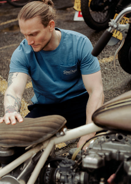 Steve inspecting a chopper wearing our Bike Shed Motorcycle Co. Embroidered Pocket T Shirt - Blue