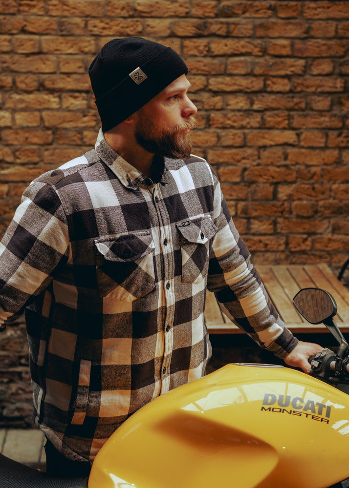 Jimbo standing with his bike wearing our BSMC Simple Beanie - Black