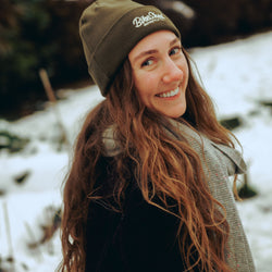 Leoma smiling and wearing our chain stitch beanie 