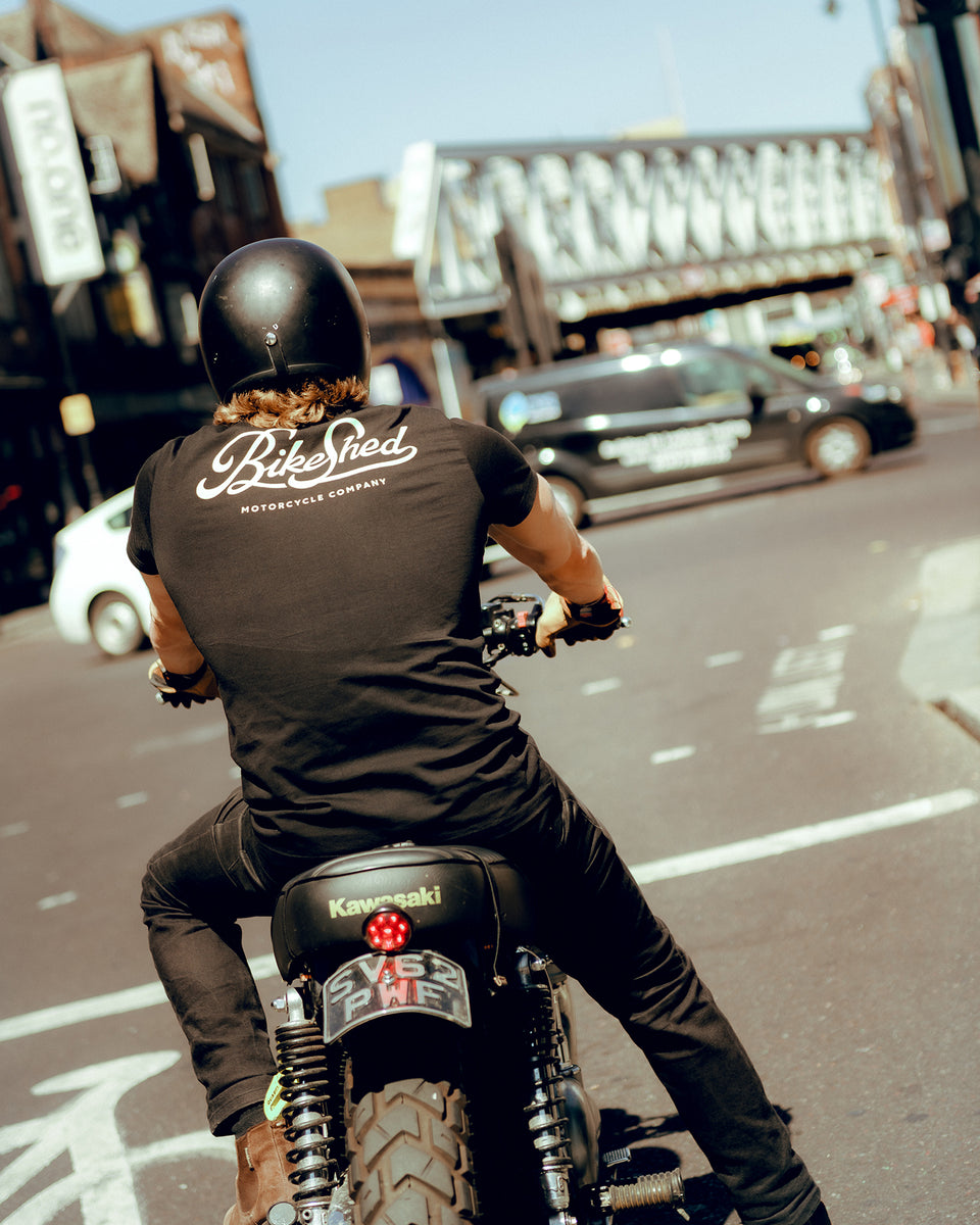 Harry on his bike at the lights wearing our BSMC Motorcycle Garage T Shirt - Black & Gold