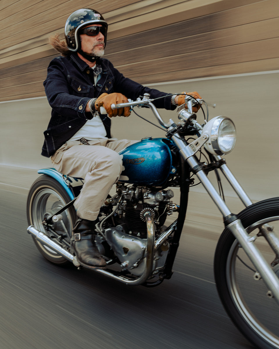 John wearing our BSMC Denim Jacket - Resistant Indigo riding his Triumph