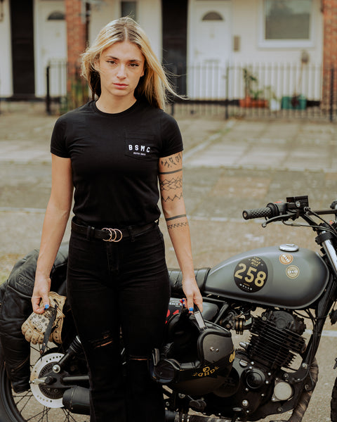 Model wearing our BSMC Women's ESTD. Pocket T Shirt - Black next to her Mutt