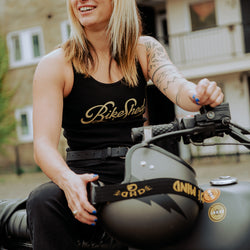 Model sitting on her bike wearing our BSMC Women's Garage Vest - Black