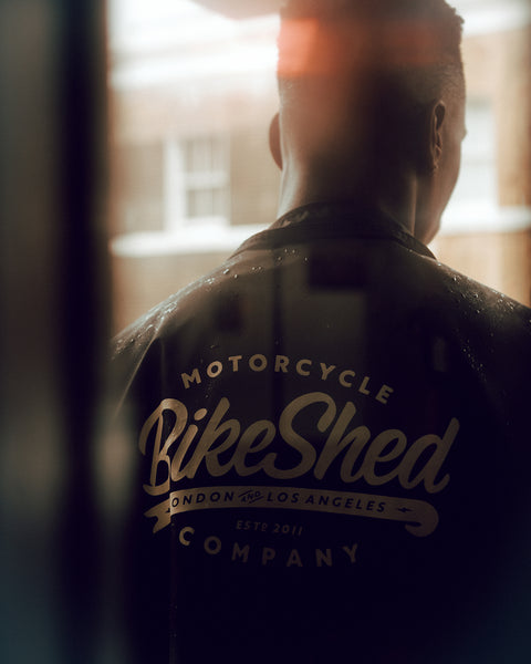 Model wearing our BSMC Company Coach Motorcycle Jacket - Black in artistic lighting