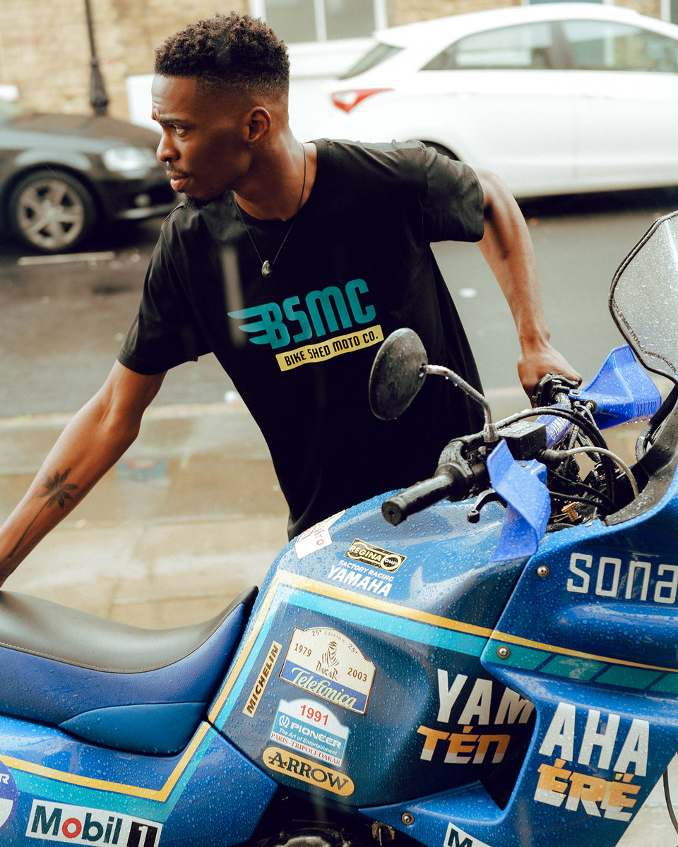 Model wheeling his bike wearing our BSMC XT Motorcycle Logo T-Shirt - Black