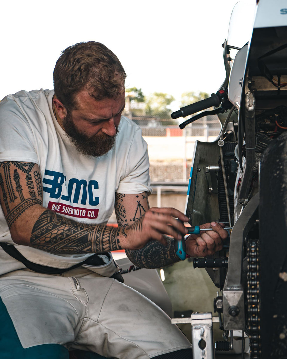 Mark wearing our BSMC XT Motorcycle Logo T-Shirt - Off White working on his bike