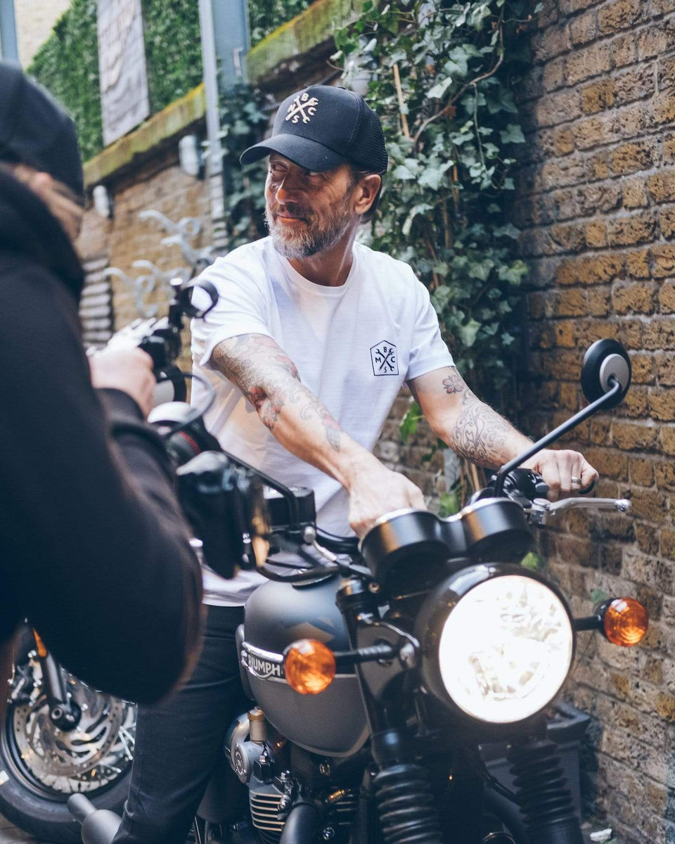 Dutch sitting on a Triumph Bonnie wearing our BSMC 1580 Roundel T Shirt - White