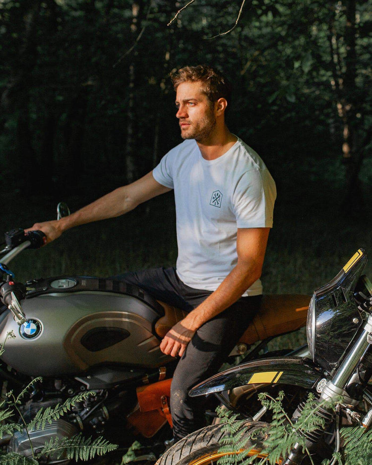 Model sitting on a BMW R Nine T In the forest wearing our BSMC 1580 Roundel T Shirt - White