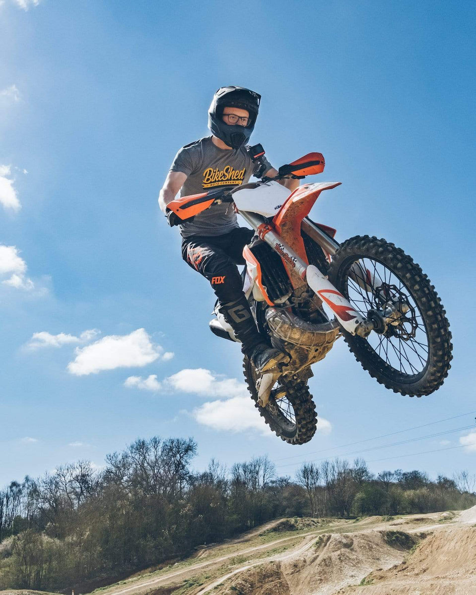 Dirt bike rider going over jump wearing our BSMC Classic T-Shirt - Grey