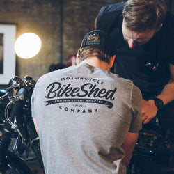 Harry wearing our BSMC Company T-Shirt - Grey while working on his bike