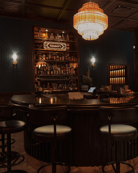 Dimmly lit Tommy's Bar and seating