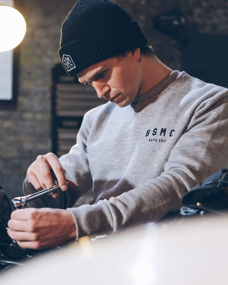 Harry working on his bike wearing our Bike Shed Motorcycle Logo Sweatshirt - Grey Marl