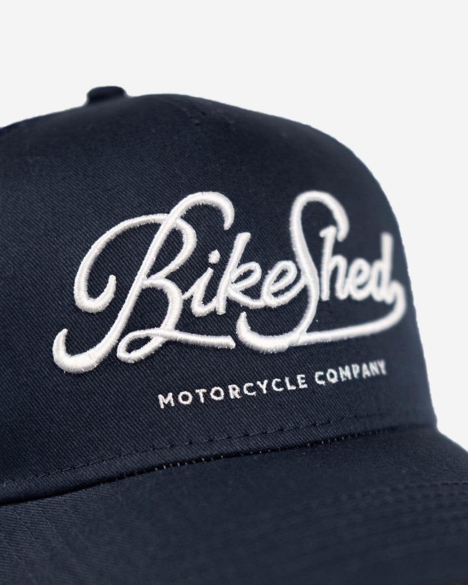 BSMC Motorcycle Garage Baseball Hat - Navy/White, logo close up