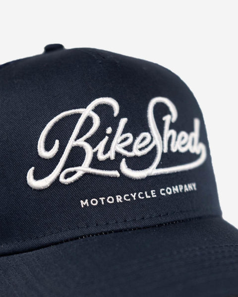 BSMC Motorcycle Garage Baseball Hat - Navy/White, logo close up