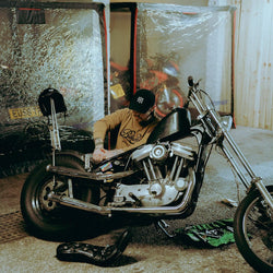 James working on his Harley while wearing our BSMC Garage Sweat - Tan/Black