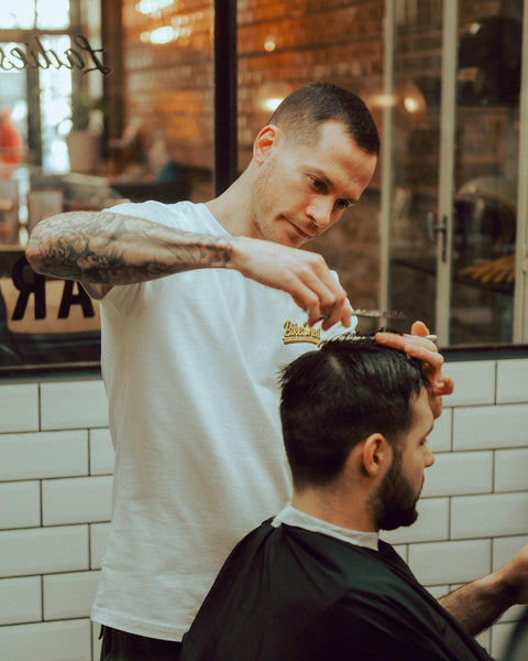 Luca wearing our BSMC Motorcycle Mural Graphic T Shirt - White cutting hair