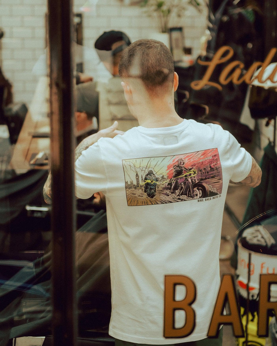 Luca wearing our BSMC Motorcycle Mural Graphic T Shirt - White while cutting hair