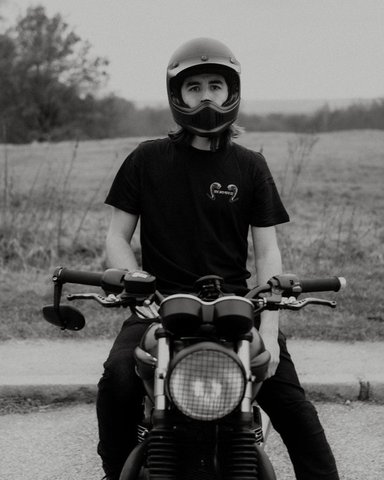 Dan wearing our BSMC Pan T-Shirt sitting on his Triumph
