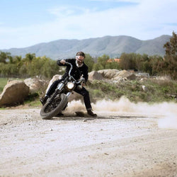 Model kicking up dust on his Harley while wearing our BSMC Resistant - BSR01 Jean - Raw Indigo