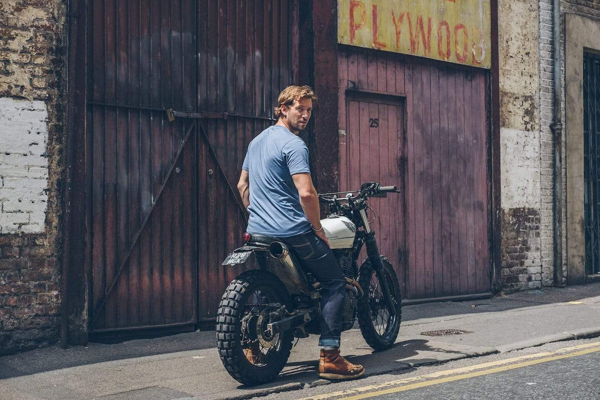 Model sitting on his Honda wearing our Motorcycle Resistant - BSR01 Jeans - Raw Indigo