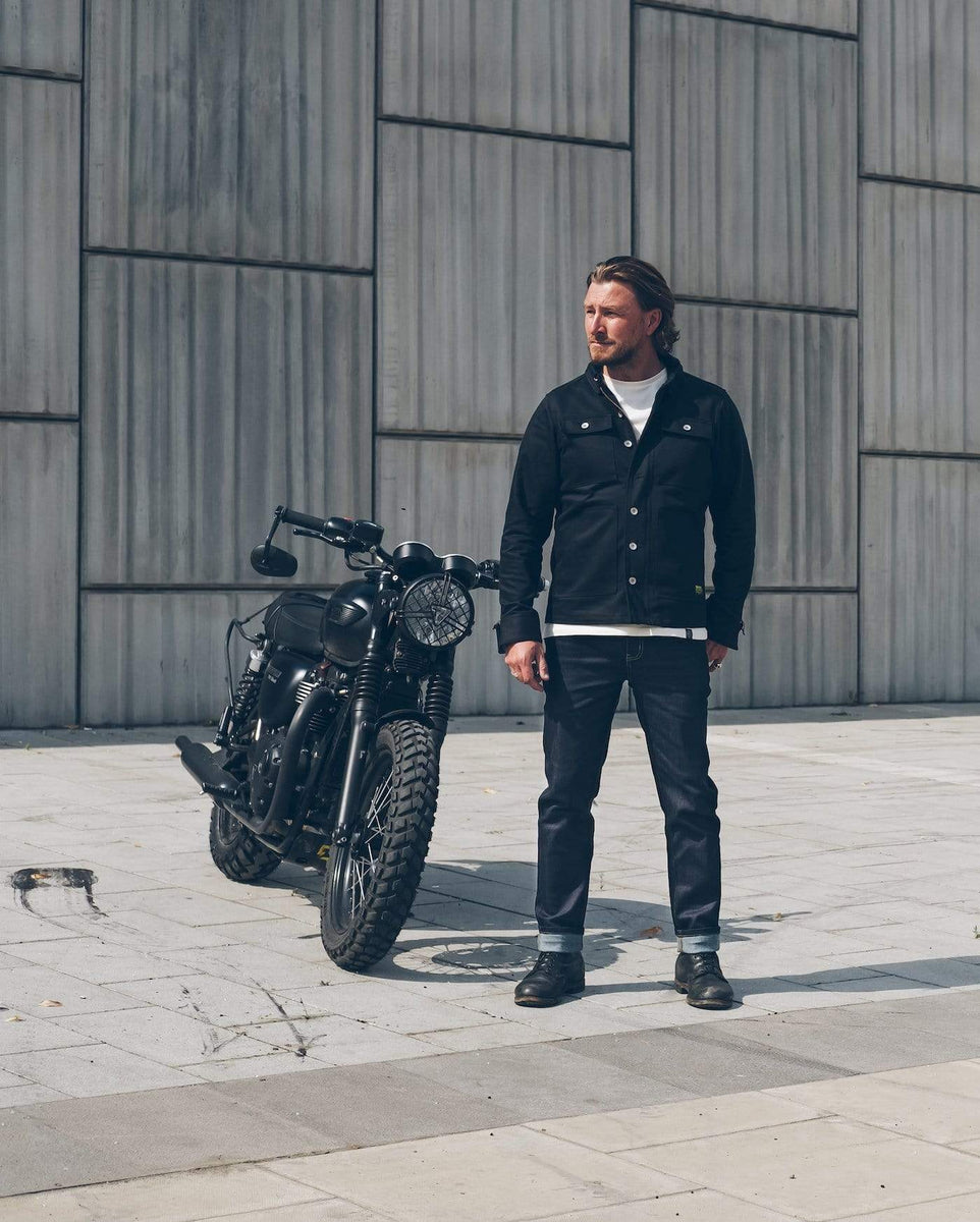 Donny, wearing our Motorcycle Resistant - BSR01 Jeans - Raw Indigo standing next to his Triumph