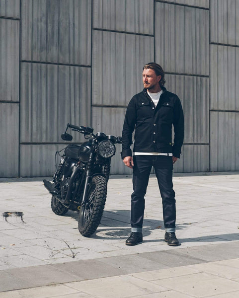 Donny, wearing our Motorcycle Resistant - BSR01 Jeans - Raw Indigo standing next to his Triumph