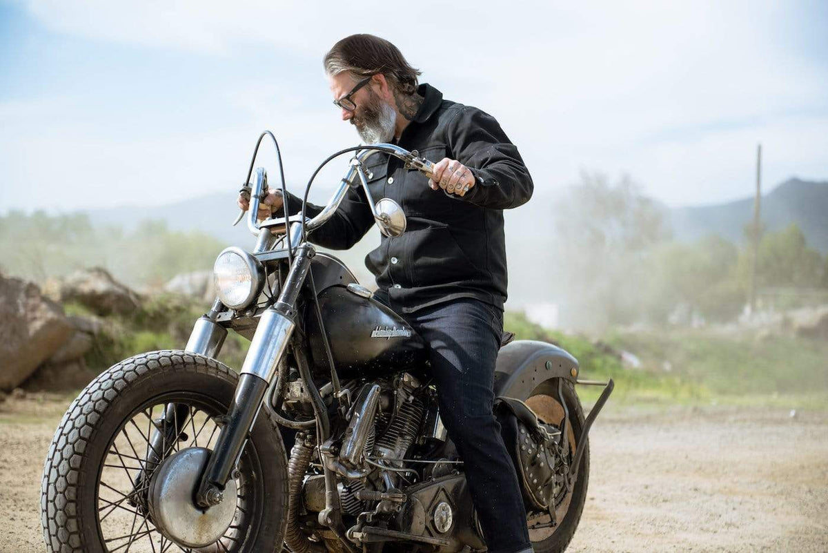 Model wearing our Motorcycle Resistant - BSR01 Jeans - Raw Indigo while sitting on his bike