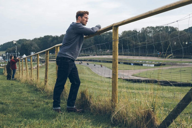 Model by a racetrack wearing our BSMC Resistant - BSR01 Jean - Raw Indigo