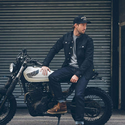 Model sitting on his bike wearing our BSMC Resistant Overshirt - Black