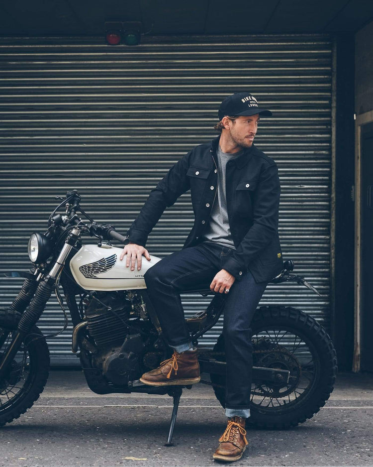 Model sitting on his bike wearing our BSMC Resistant Overshirt - Black