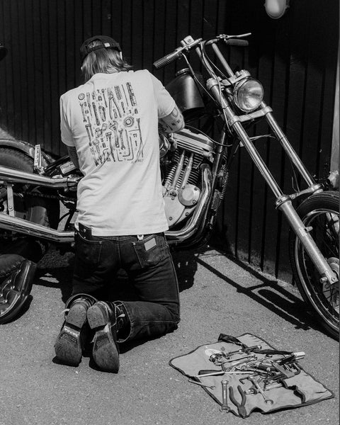 James working on his bike wearing our BSMC Motorcycle Toolkit Graphic T Shirt  - White