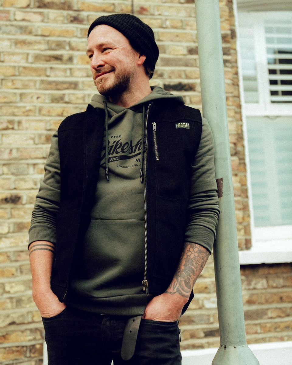 Donny wearing our Motorcycle utility vest with multiple pockets and zipper detailing.- Black