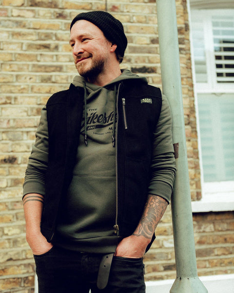 Donny wearing our Motorcycle utility vest with multiple pockets and zipper detailing.- Black