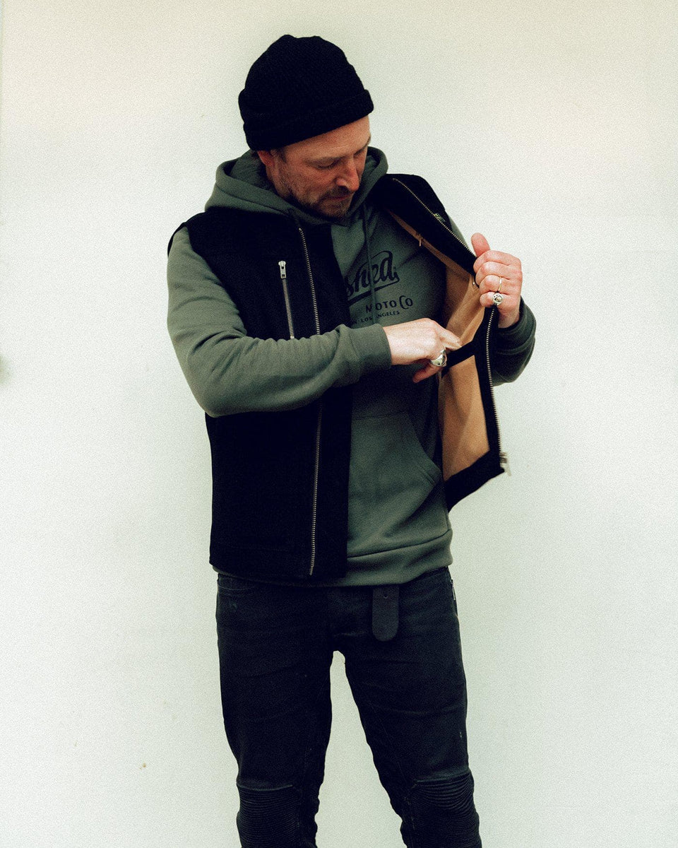 Donny posing wearing our Motorcycle utility vest with multiple pockets and zipper detailing - Black