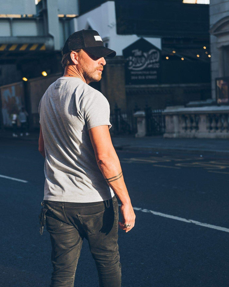 Donny outside the Bike Shed London wearing our BSMC x Royal Enfield Inverse T Shirt - Grey