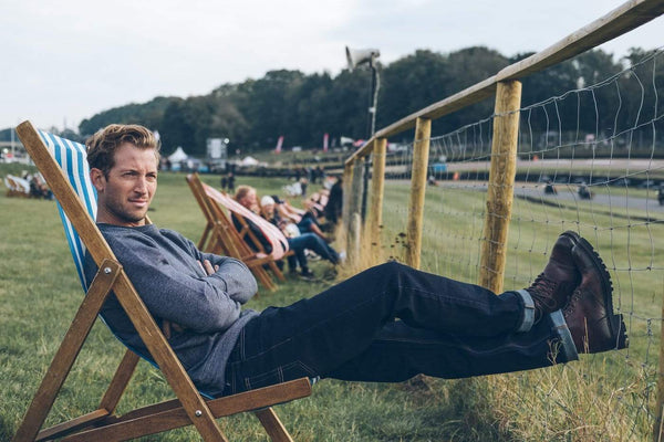 Model wearing BSMC X Umberto Luce Boot - Coffee Brown at a race track