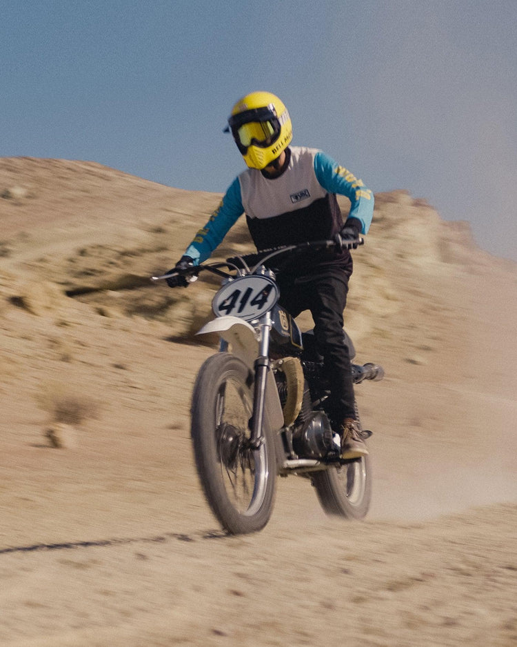 Model riding in the desert wearing our BSMC XT Race Jersey - BLUE/WHITE/BLACK
