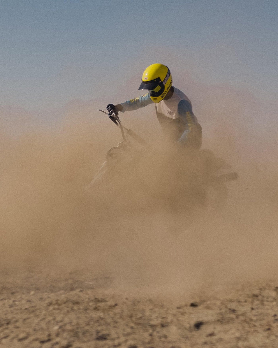 Rider kicking up dust on dirt bike wearing our BSMC XT Motorcycle Race Jersey - BLUE/WHITE/BLACK