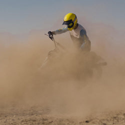 Rider kicking up dust on dirt bike wearing our BSMC XT Race Jersey - BLUE/WHITE/BLACK