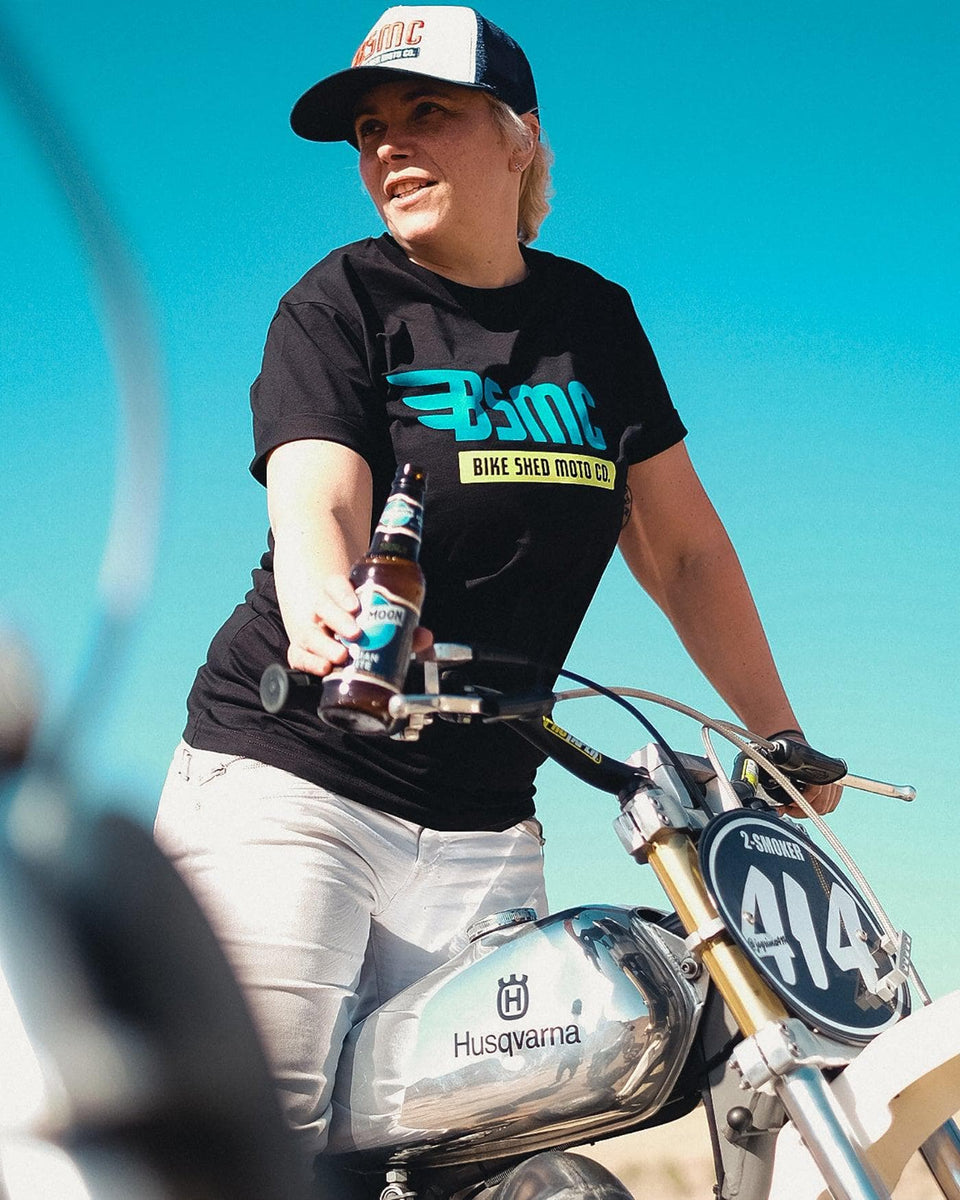 Model wearing our BSMC XT Motorcycle Logo T-Shirt - Black standing on a bike